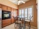 Cozy kitchen nook featuring a glass table, stylish chairs, and natural light streaming through shuttered windows at 2521 Seascape Dr, Las Vegas, NV 89128
