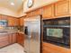 Gourmet kitchen featuring stainless steel appliances, granite counters, and custom wood cabinetry for a chef-inspired experience at 2521 Seascape Dr, Las Vegas, NV 89128