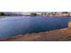 Picturesque lake view at dusk with the neighborhood's houses in the background at 2521 Seascape Dr, Las Vegas, NV 89128