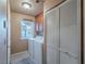 Convenient laundry room area with washer, dryer and built-in shelving at 2521 Seascape Dr, Las Vegas, NV 89128