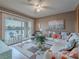 Inviting living room featuring a ceiling fan and lake view from the connected balcony at 2521 Seascape Dr, Las Vegas, NV 89128