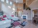 Bright living room with fireplace, expansive windows and large sectional sofa at 2521 Seascape Dr, Las Vegas, NV 89128