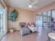 Cozy sunroom area with comfortable seating, a ceiling fan, and views of the outdoors at 2521 Seascape Dr, Las Vegas, NV 89128