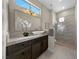 Modern bathroom features a stone countertop, vessel sink, decorative lighting and a glass enclosed shower at 2548 Faiss Dr, Las Vegas, NV 89134