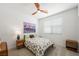 Comfortable bedroom featuring a ceiling fan, a large window, and stylish decor at 2555 Hampton Rd # 9307, Henderson, NV 89052