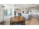 Bright breakfast nook showcases a wooden round table, and natural light from a large picture window with neighborhood views at 2555 Hampton Rd # 9307, Henderson, NV 89052