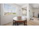 Bright breakfast nook showcases a wooden round table, and natural light from a large picture window with neighborhood views at 2555 Hampton Rd # 9307, Henderson, NV 89052