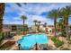 A gorgeous community pool with palm trees and lounge chairs offers a resort-style experience at 2555 Hampton Rd # 9307, Henderson, NV 89052