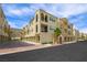 Beautiful stucco condo building featuring arched entrances and balconies, set against a sunny sky at 2555 Hampton Rd # 9307, Henderson, NV 89052