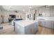 Open-concept kitchen with a large island, stainless appliances, and modern cabinets flows into the adjacent living room at 2555 Hampton Rd # 9307, Henderson, NV 89052