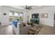 Bright living room with balcony access and open floorplan flowing into a kitchen area at 2555 Hampton Rd # 9307, Henderson, NV 89052