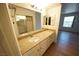 Bathroom featuring granite countertops, a sink, and a large mirror, with a window for natural light at 2606 S Durango Dr # 165, Las Vegas, NV 89117