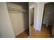 Spacious walk-in closet with mirrored doors, ample storage space and wood floors at 2606 S Durango Dr # 165, Las Vegas, NV 89117