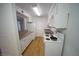 Bright kitchen featuring white cabinets, granite countertops, and white appliances at 2606 S Durango Dr # 165, Las Vegas, NV 89117