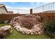 Backyard featuring a unique rock waterfall and landscaping, creating a serene outdoor space at 2787 Sunken Ship St, Laughlin, NV 89029