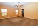 Bedroom with neutral carpet, ceiling fan, and view of bathroom at 2787 Sunken Ship St, Laughlin, NV 89029