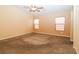 Bedroom with neutral carpet, ceiling fan, and two windows at 2787 Sunken Ship St, Laughlin, NV 89029
