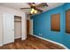 Bright bedroom boasts wood floors, a ceiling fan, and a closet with a white door at 2787 Sunken Ship St, Laughlin, NV 89029