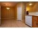 Cozy dining area features a chandelier, neutral paint, tile flooring and convenient access to the kitchen at 2787 Sunken Ship St, Laughlin, NV 89029