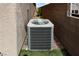 Side yard includes newer air conditioning unit with small trees and gravel at 2787 Sunken Ship St, Laughlin, NV 89029