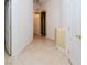 Neutral hallway features tile flooring, white trim, and arched doorway at 2787 Sunken Ship St, Laughlin, NV 89029