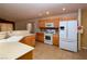 Spacious kitchen featuring light wood cabinetry, modern appliances, ample counter space, and tile flooring at 2787 Sunken Ship St, Laughlin, NV 89029