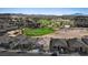 An aerial view of a home near a golf course, showcasing its tiled roof and desert landscaping at 305 Via Del Duomo, Henderson, NV 89011