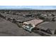 Aerial view of a home with a pool, outdoor kitchen, covered patio and mountain views at 305 Via Del Duomo, Henderson, NV 89011