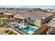 An aerial view showcases the backyard with its outdoor kitchen, covered patio, pool, and spa at 305 Via Del Duomo, Henderson, NV 89011