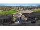 An aerial view of a home near a golf course, showcasing its tiled roof and desert landscaping at 305 Via Del Duomo, Henderson, NV 89011