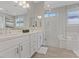 Bright bathroom offers dual sinks with large mirrors, glass-enclosed shower and soaking tub at 305 Via Del Duomo, Henderson, NV 89011