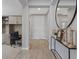A modern entryway with wood floors, gray walls, decor, and a view to an office and the front door at 305 Via Del Duomo, Henderson, NV 89011
