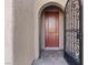 Close-up of a home's inviting front door with iron security door and brick walkway at 305 Via Del Duomo, Henderson, NV 89011