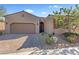 Charming single-story home featuring a desert landscape, and a two car garage on a sunny day at 305 Via Del Duomo, Henderson, NV 89011
