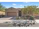 Charming single-story home featuring a desert landscape, and a two car garage on a sunny day at 305 Via Del Duomo, Henderson, NV 89011