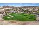Picturesque aerial view showcases the lush green golf course and surrounding homes at 305 Via Del Duomo, Henderson, NV 89011