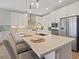 Bright kitchen with stainless appliances, tile backsplash, quartz countertops, and pendant lighting at 305 Via Del Duomo, Henderson, NV 89011
