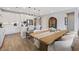 This bright kitchen features stainless appliances, quartz countertops, pendant lighting, dining table, and island at 305 Via Del Duomo, Henderson, NV 89011