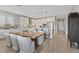 This kitchen features stainless appliances, quartz counters, pendant lights, an island, and adjacent dining at 305 Via Del Duomo, Henderson, NV 89011