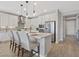 This bright kitchen offers stainless appliances, quartz countertops, pendant lighting, and counter seating at 305 Via Del Duomo, Henderson, NV 89011