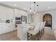 Bright kitchen with stainless appliances, quartz countertops, pendant lighting, and island seating at 305 Via Del Duomo, Henderson, NV 89011