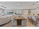Open-concept living space with modern furnishings, dining area, and a kitchen with white cabinets at 305 Via Del Duomo, Henderson, NV 89011