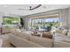 Open living room featuring modern decor, large windows, and a seamless connection to the outdoor living space at 305 Via Del Duomo, Henderson, NV 89011