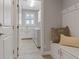 Mudroom featuring a bench with storage and hooks, washer and dryer, and white shaker cabinets at 305 Via Del Duomo, Henderson, NV 89011