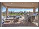 Covered patio features outdoor seating with a grill and views of the community golf course at 305 Via Del Duomo, Henderson, NV 89011