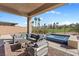 Inviting covered patio with comfortable seating and a tranquil view of the golf course at 305 Via Del Duomo, Henderson, NV 89011