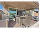 Covered patio with outdoor kitchen, grill, seating, and a large sliding glass door into the home at 305 Via Del Duomo, Henderson, NV 89011