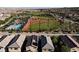 Aerial view of community baseball field, pool, residences, and rooftop solar panels at 3084 Porte La Paz Ave, Henderson, NV 89044