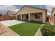 Backyard with covered patio, artificial grass and gravel landscaping at 3084 Porte La Paz Ave, Henderson, NV 89044