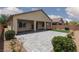 This beautiful backyard features a paver patio, covered porch, and artificial turf at 3084 Porte La Paz Ave, Henderson, NV 89044
